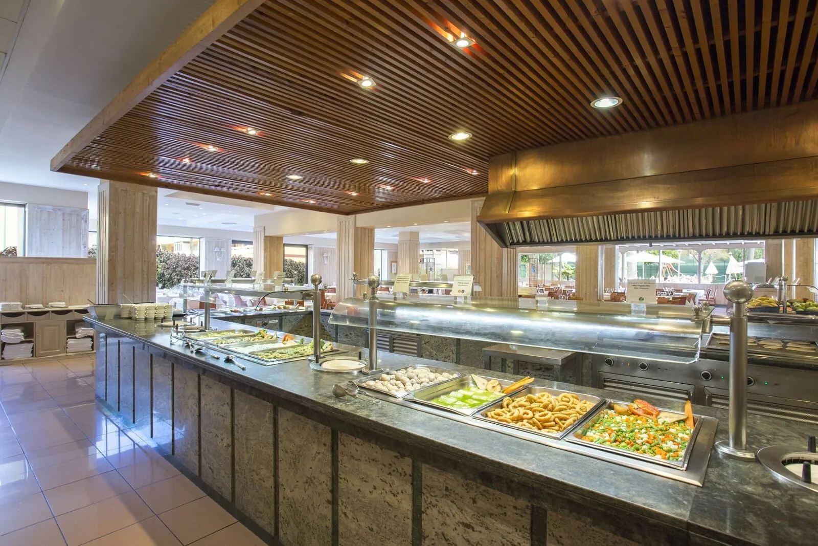 Be Live Adults Only Tenerife: A buffet area with various food options, a wooden ceiling, and a spacious layout