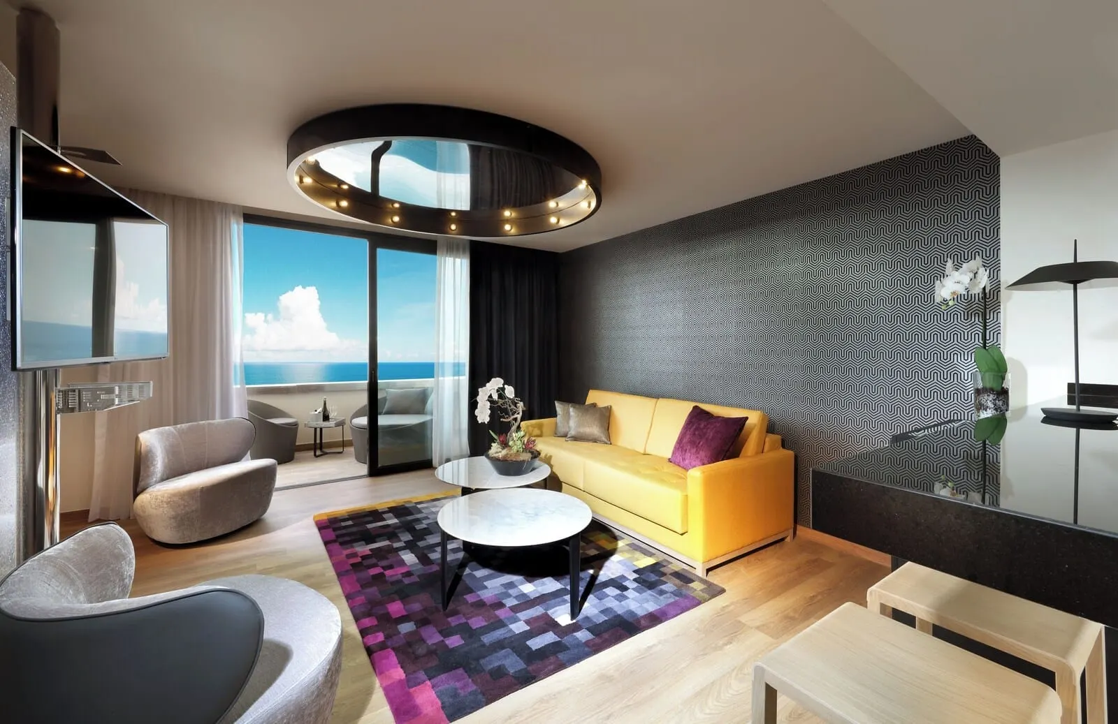 Hard Rock Hotel Tenerife: A modern living room with a yellow sofa, a round coffee table