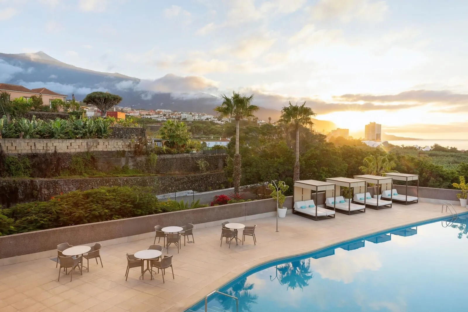 AluaSoul Orotava Valley: A poolside area with lounge chairs and tables
