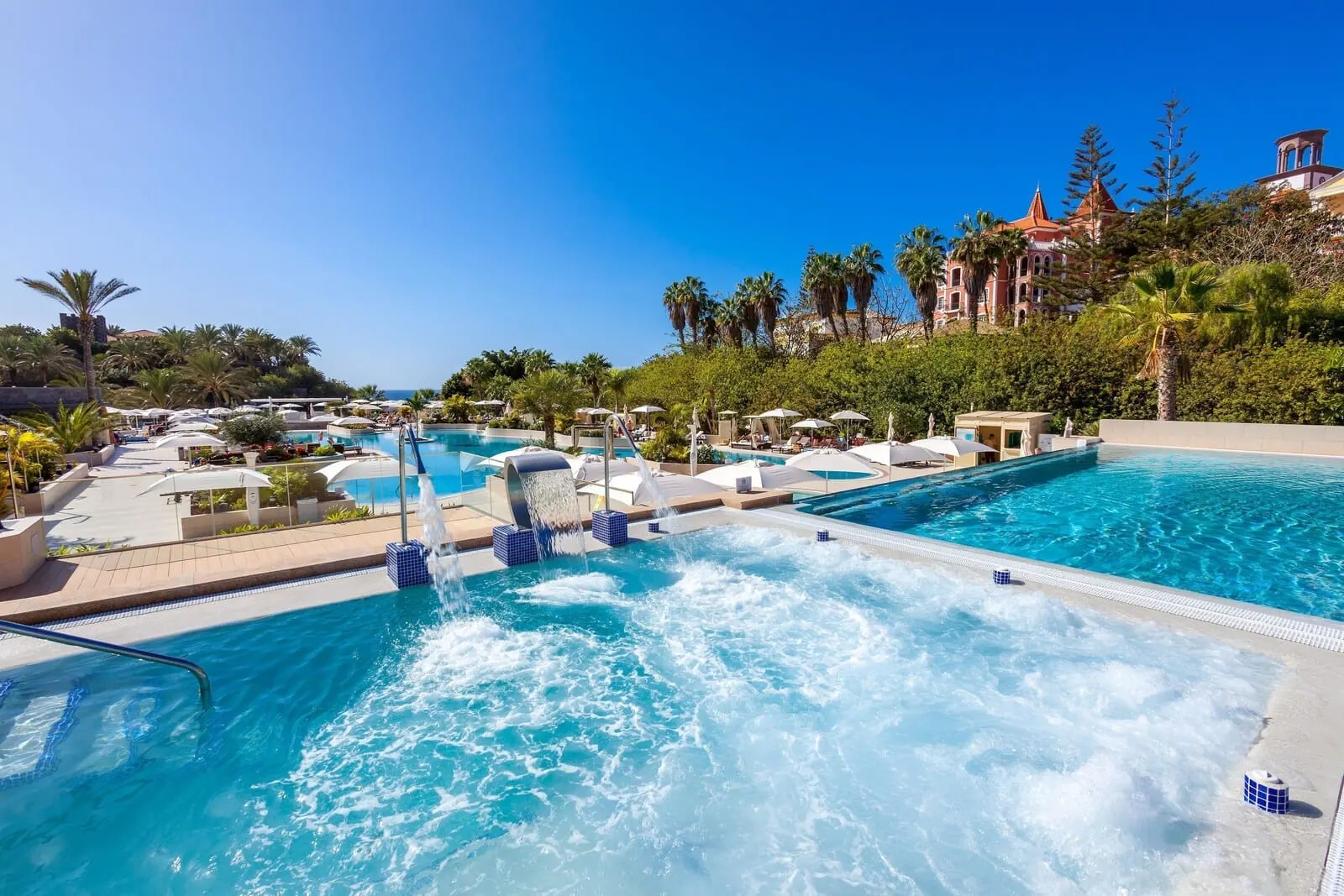 Gran Tacande Wellness & Relax: A resort pool area with multiple pools, lounge chairs, and umbrellas
