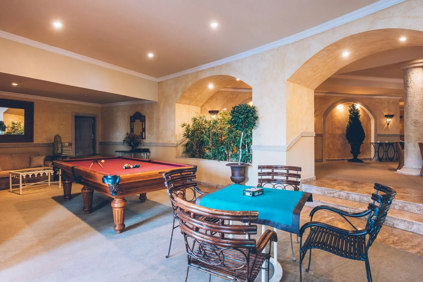 JOIA El Mirador by Iberostar: A pool table with surrounding chairs and a table, a potted plant