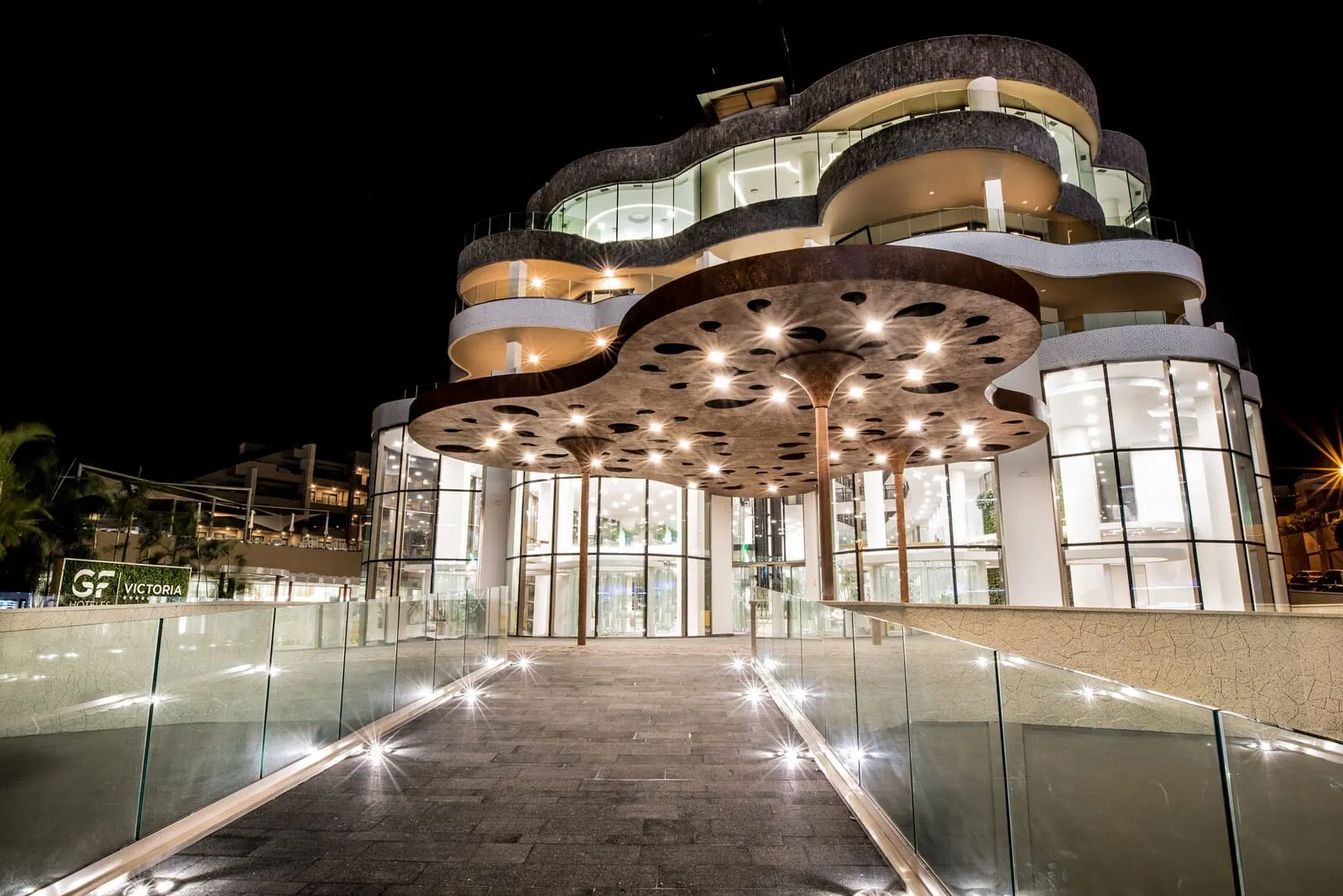 GF Victoria: A modern hotel with a unique architectural design featuring curved balconies and a glass