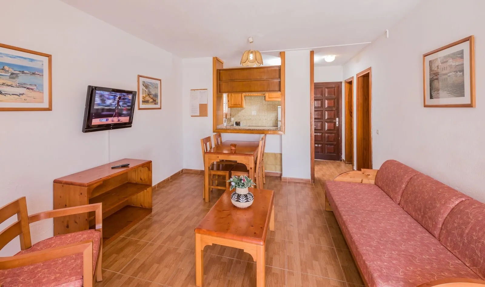 Tinerfe Garden: A living room with a wooden dining table, chairs, a sofa, a TV