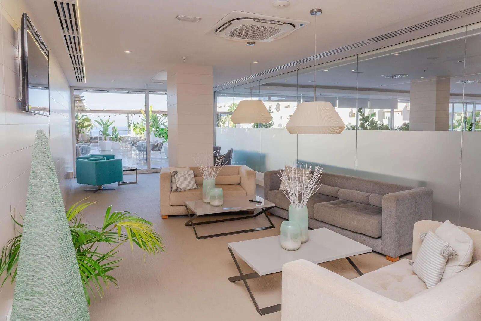 Landmar Playa la Arena: A modern lobby with a sofa, coffee table, and decorative vases