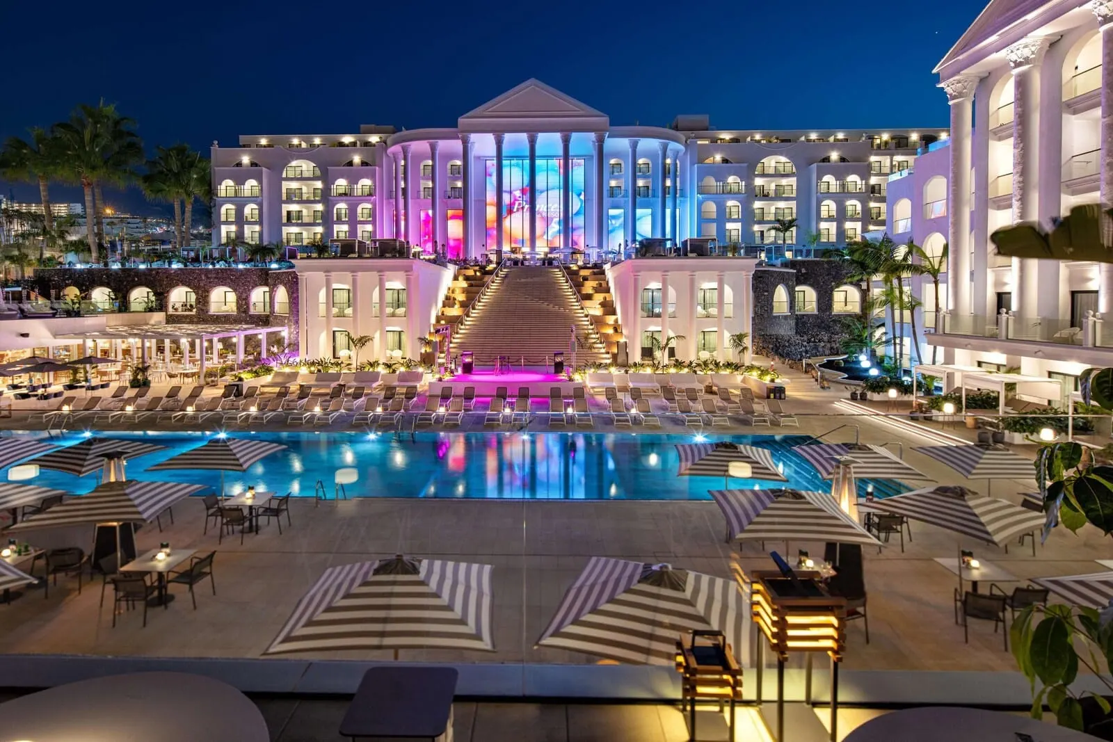 Princess Inspire Tenerife: A large hotel with a central pool, multiple balconies, and a grand entrance