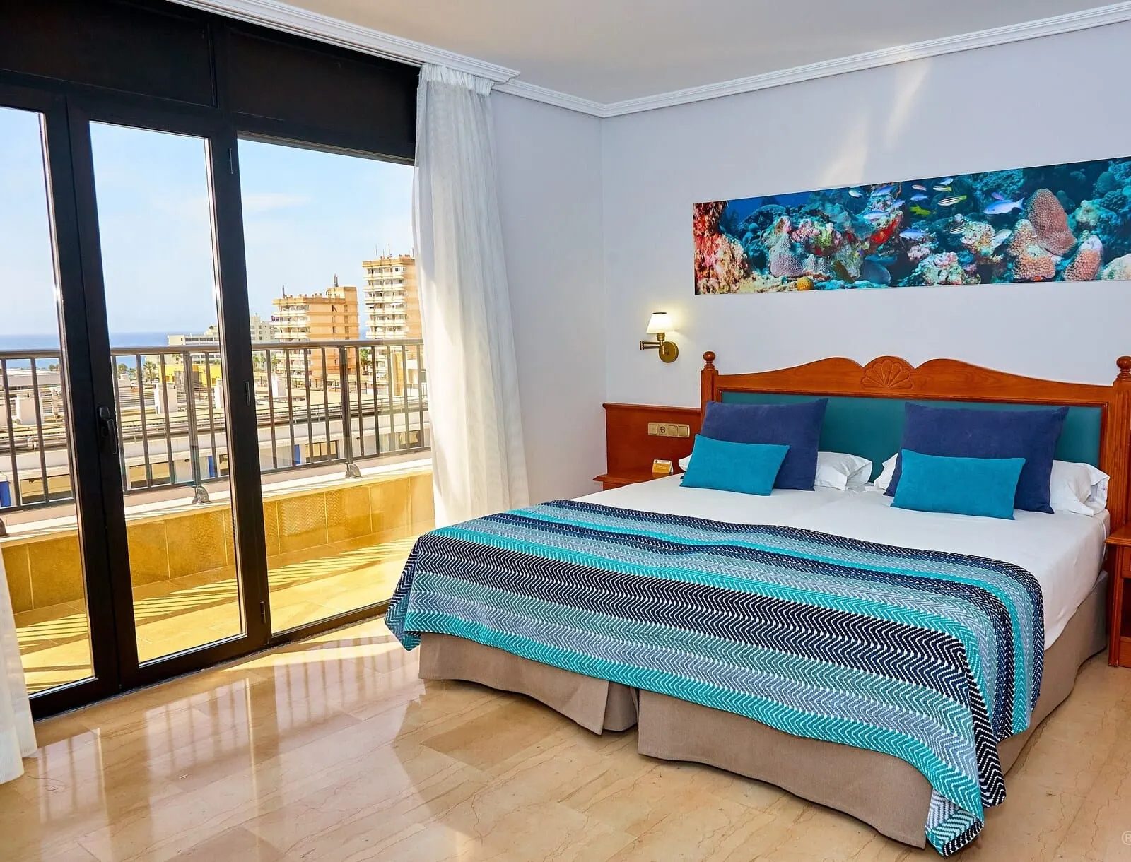 Hotel Zentral Center: A hotel room with a large bed, a city view, and a painting of fish on the wall