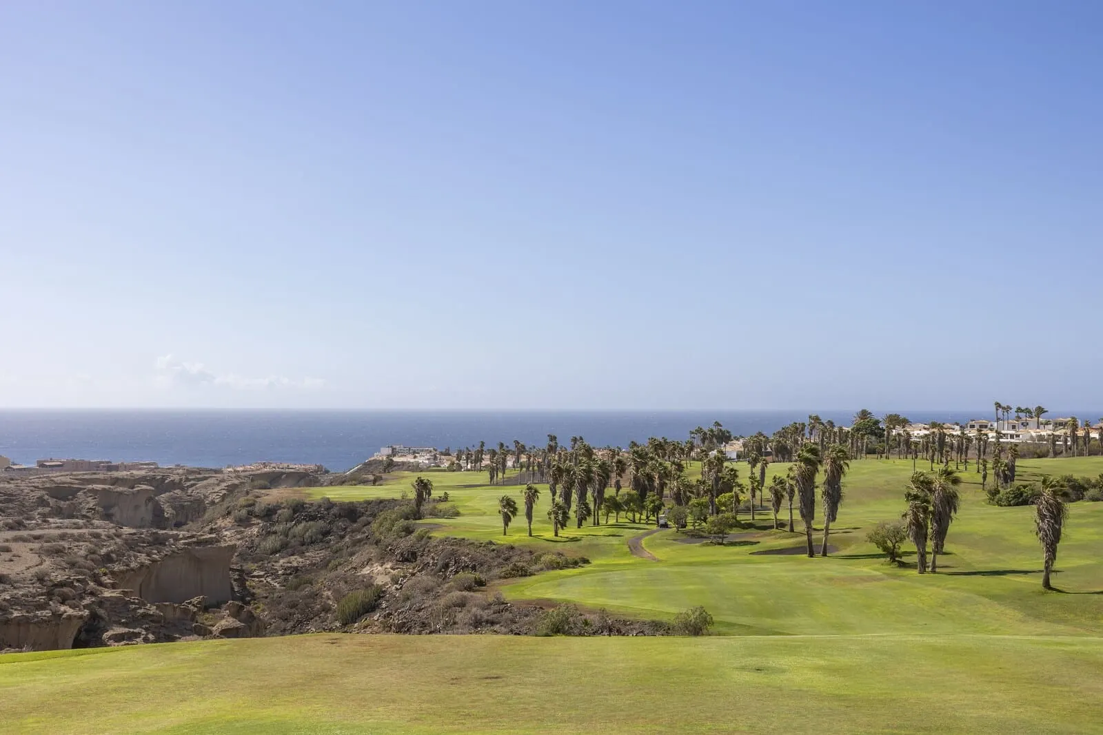 Barceló Tenerife: A golf course with a view of the ocean and a residential area in the background