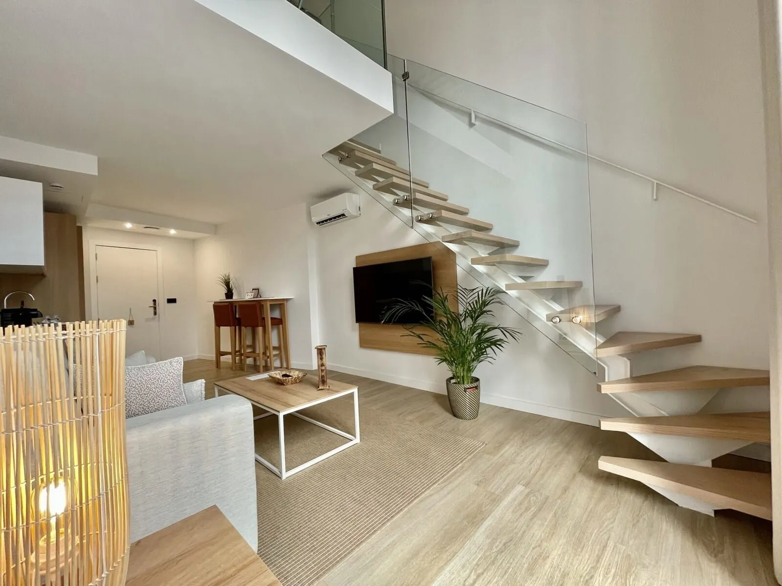 Hi Suites: A modern interior with a staircase, a dining area, and a living space