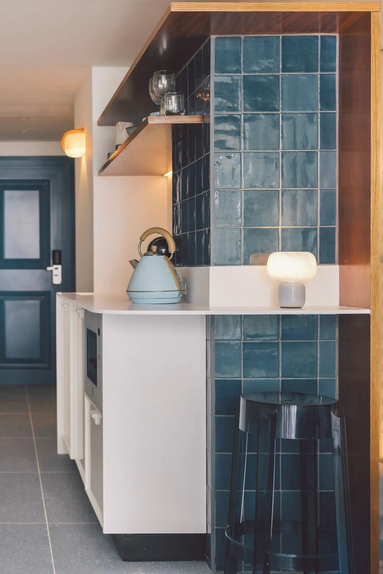The Salmar: A kitchen with a white countertop, a blue kettle, and a bar stool