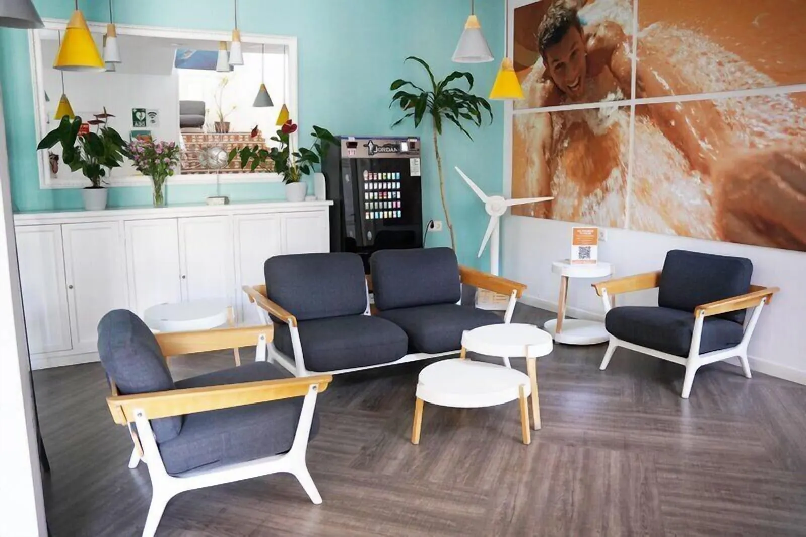 Coral Compostela Beach Golf: A modern interior with a sofa set, a small round table, and pendant lighting