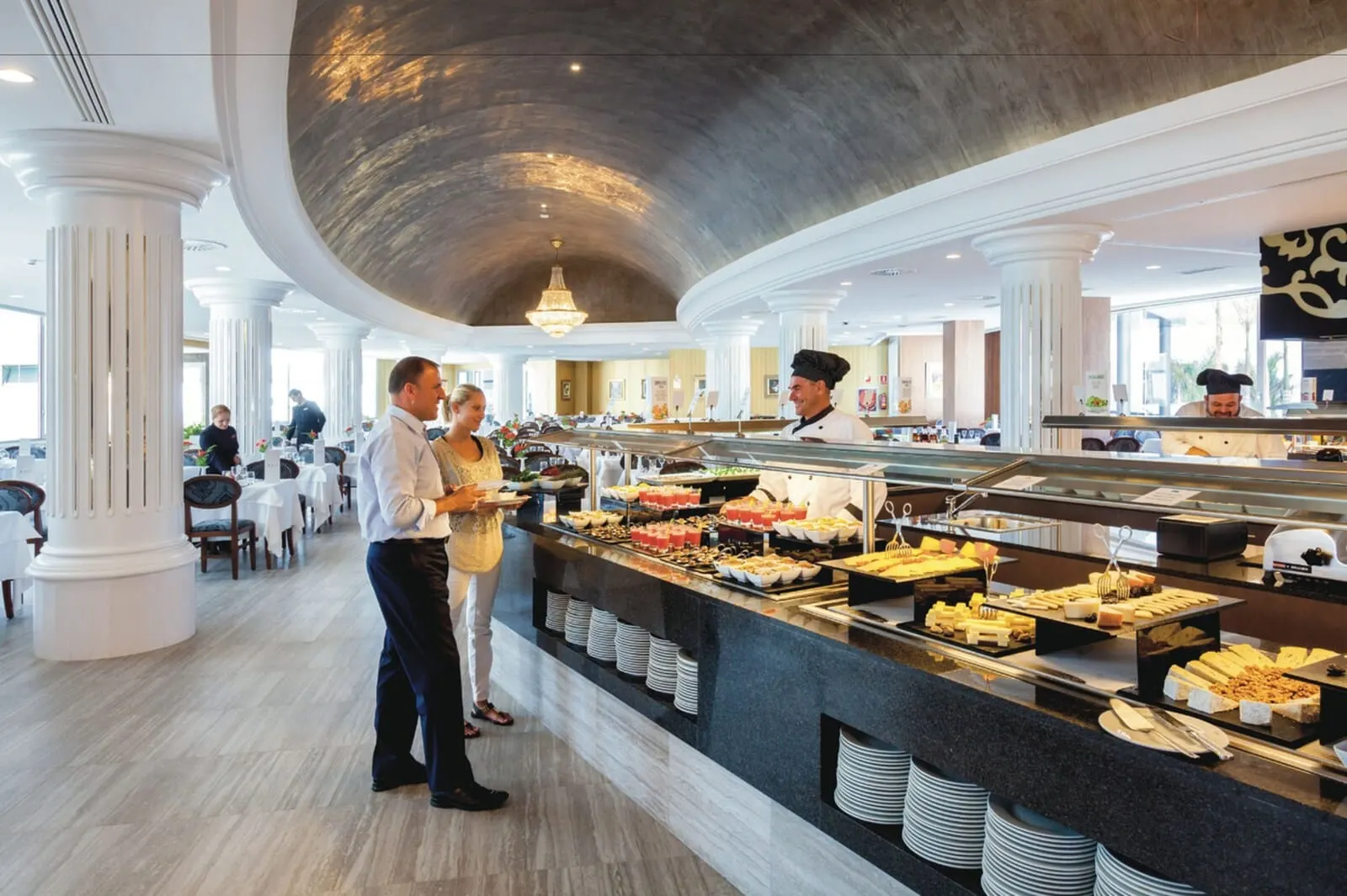 Hotel Riu Palace Tenerife: A buffet area with a variety of food options, a chef