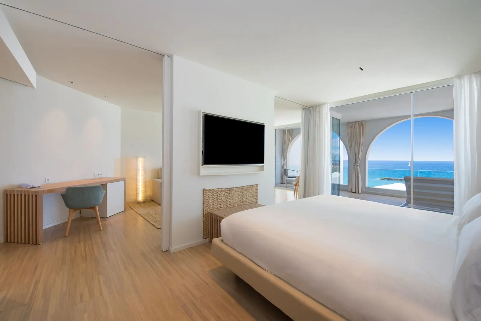 JOIA Salomé by Iberostar: A modern hotel room with a large bed, a desk, and a TV