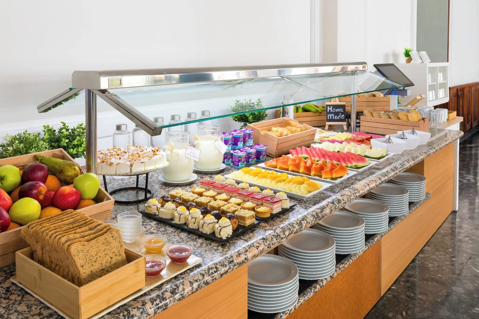 Hotel Don Manolito: A buffet with various food items, including fruits, pastries, and dairy products