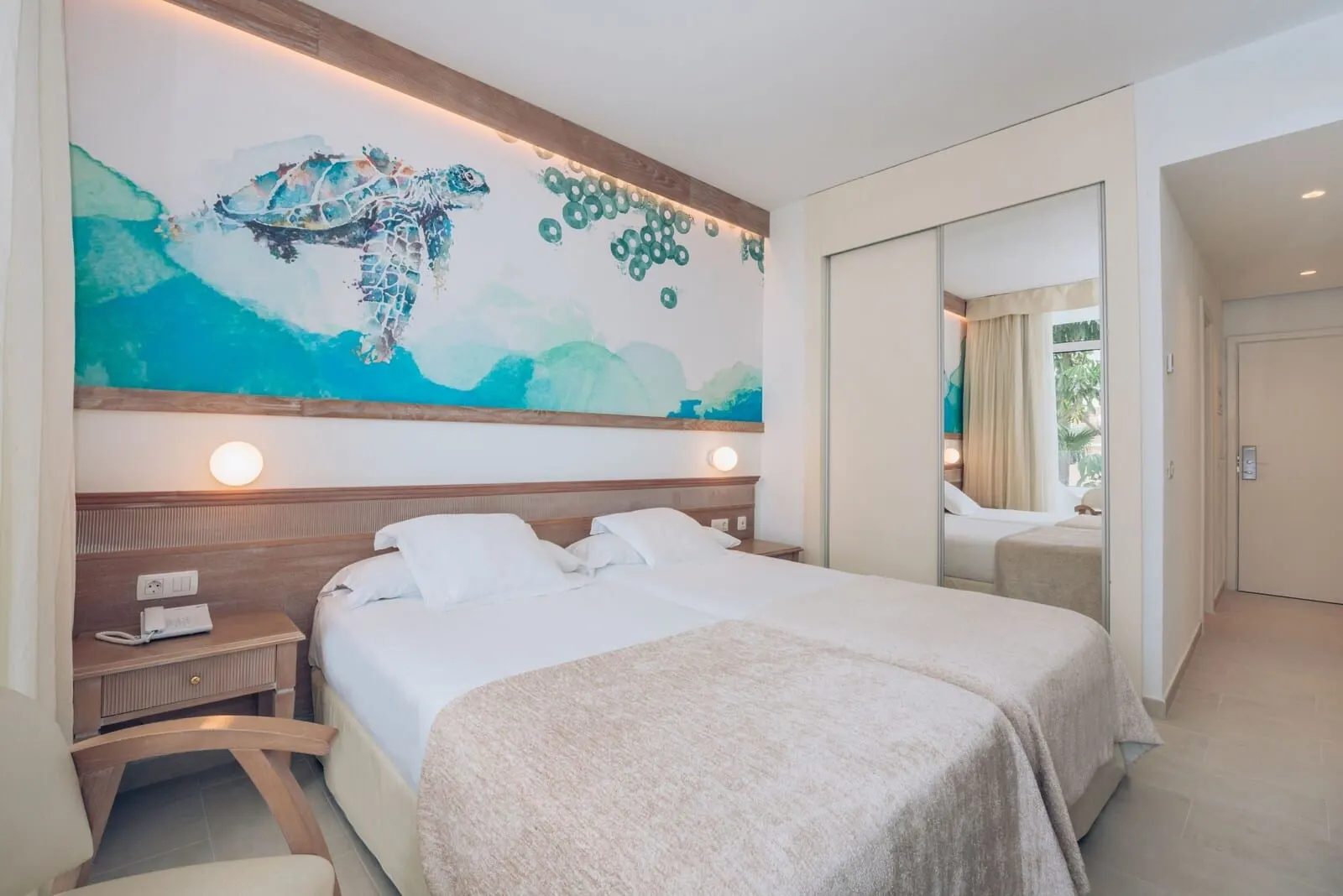 Iberostar Waves Las Dalias: A hotel room with a large bed, bedside tables, a wall-mounted artwork, and a mirror