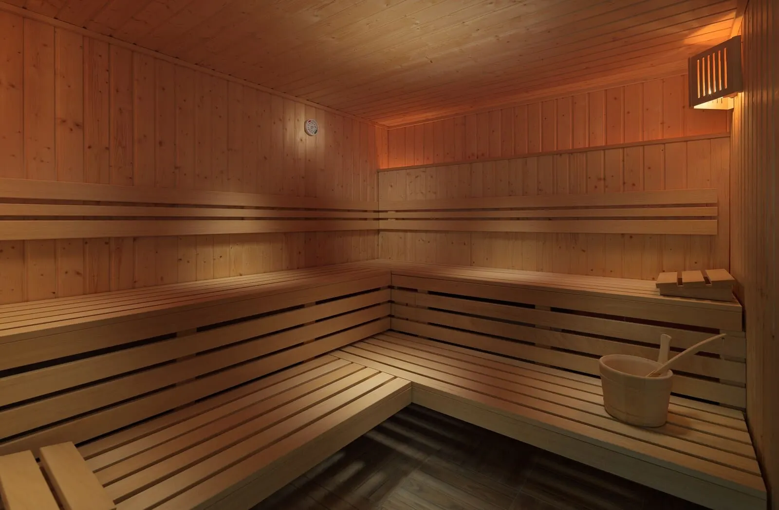 H10 Tenerife Playa: A sauna with wooden benches and a small bucket with a ladle