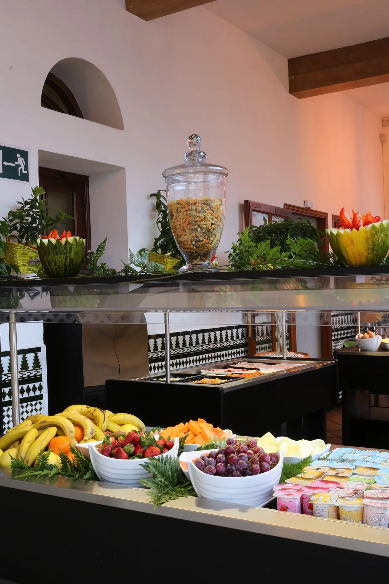 Ona Beverly Hills Suites: A buffet with various fruits, vegetables, and dairy products