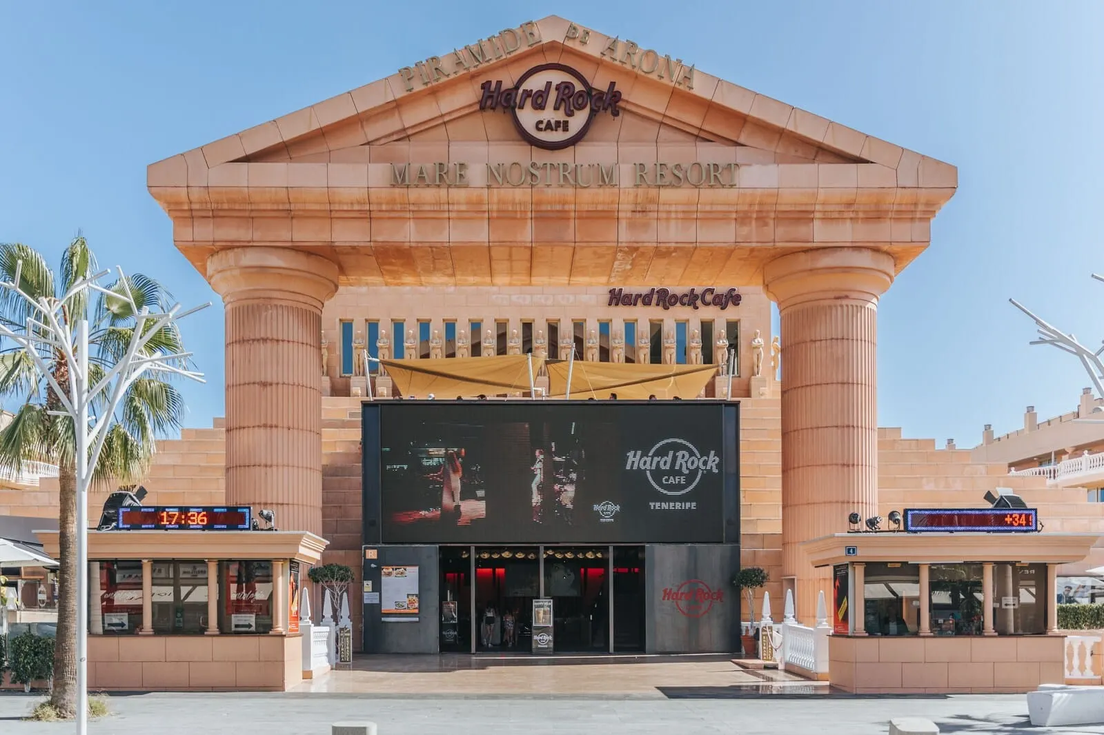 Cleopatra Palace: The Hard Rock Cafe at Mare Nostrum Resort with a large digital clock displaying 17:36