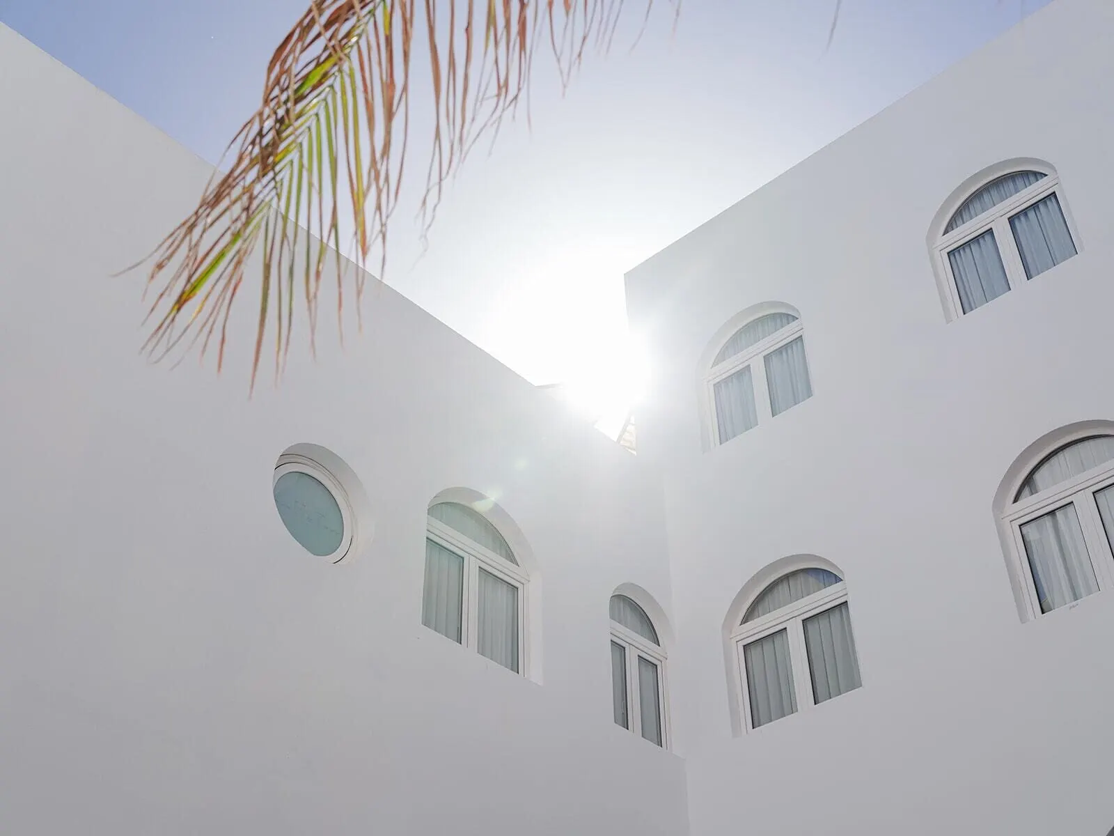 Hotel Taburiente: A white building with multiple arched windows and a central circular window