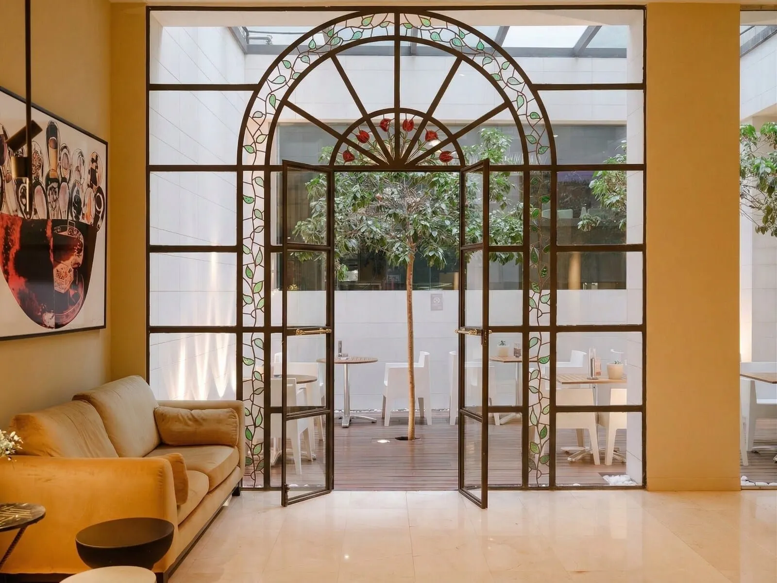 Hotel Taburiente: A modern interior with a glass door leading to an outdoor seating area