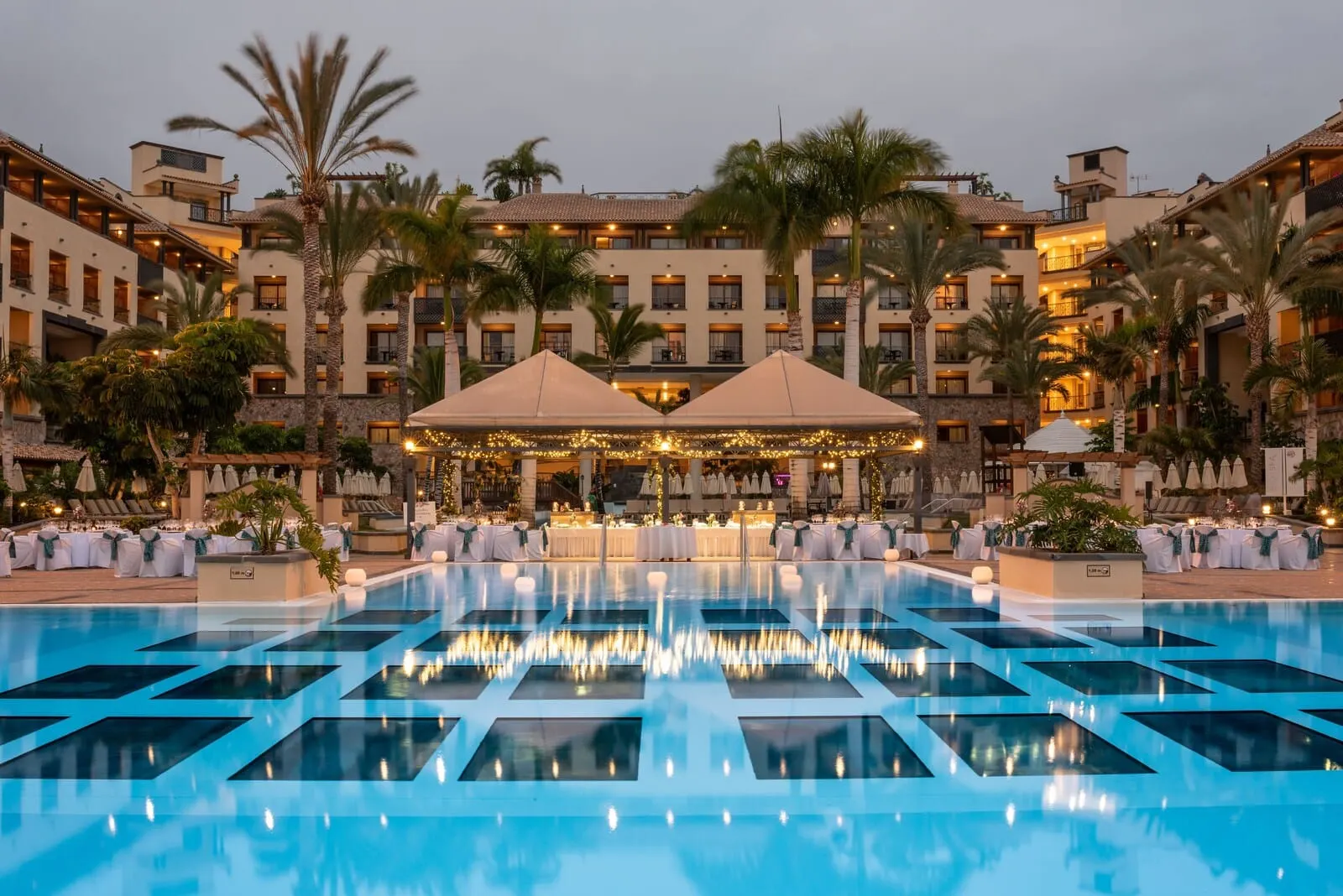 GF Gran Costa Adeje: A pool with geometric patterns, a covered seating area