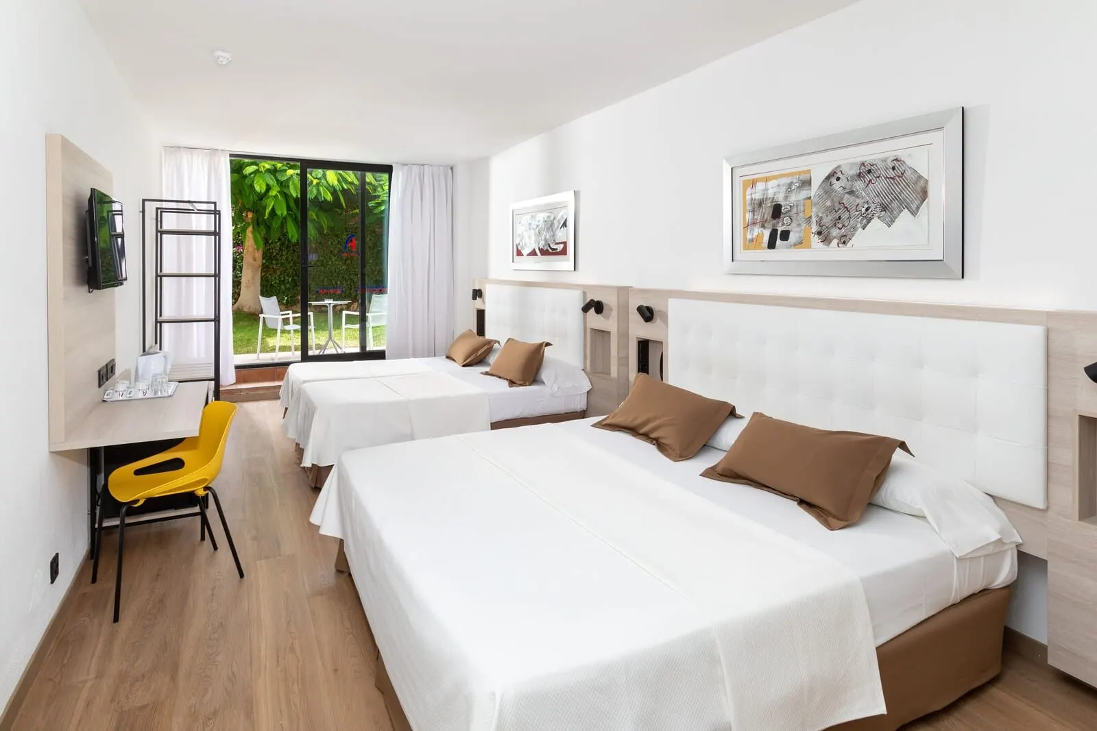 Alexandre Gala: A hotel room with two beds, a desk, a chair, and a TV