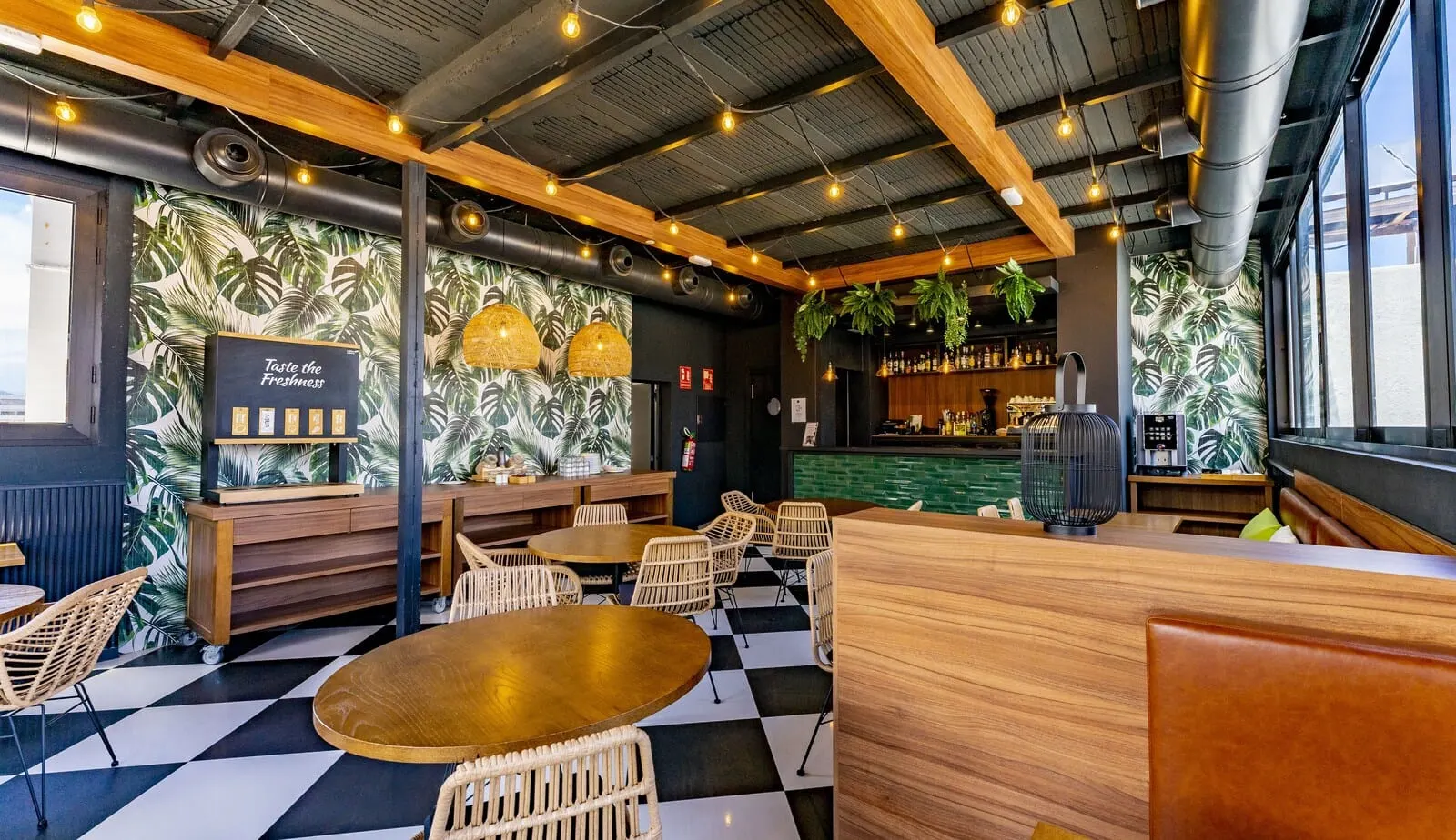 DWO Nopal: A restaurant interior with a checkered floor, wooden tables and chairs, a bar area