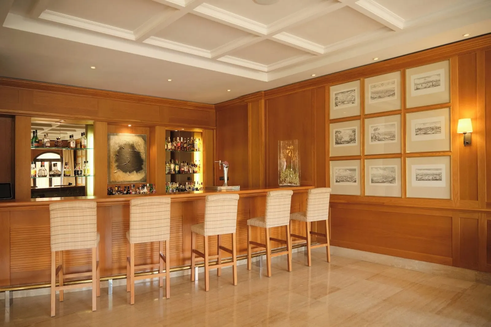 1881 Tenerife Madrigueras Golf Hotel: A bar area with wooden paneling, a polished floor, and framed artwork on the wall