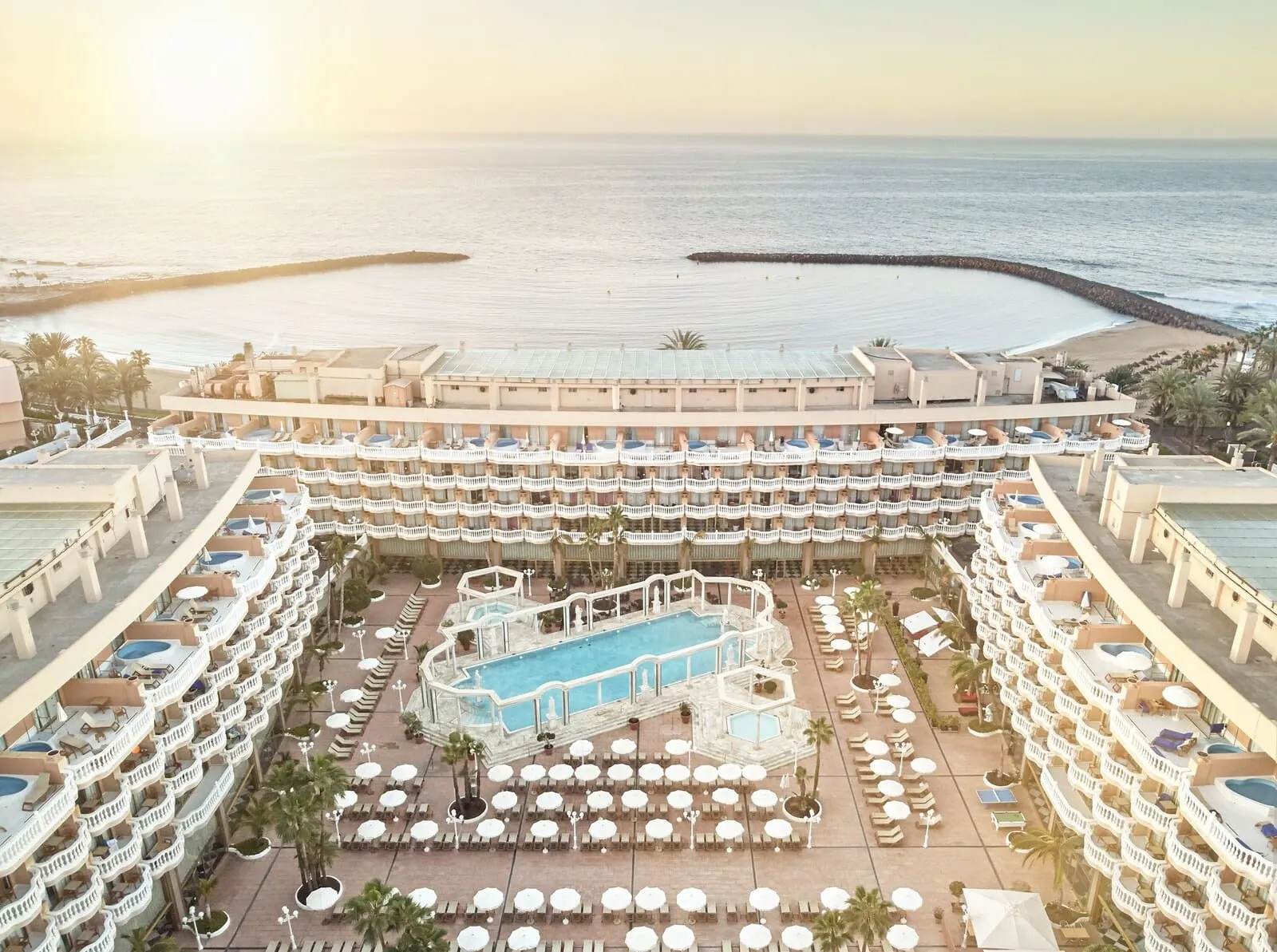 Cleopatra Palace: A resort with multiple swimming pools, sun loungers, and a beach view