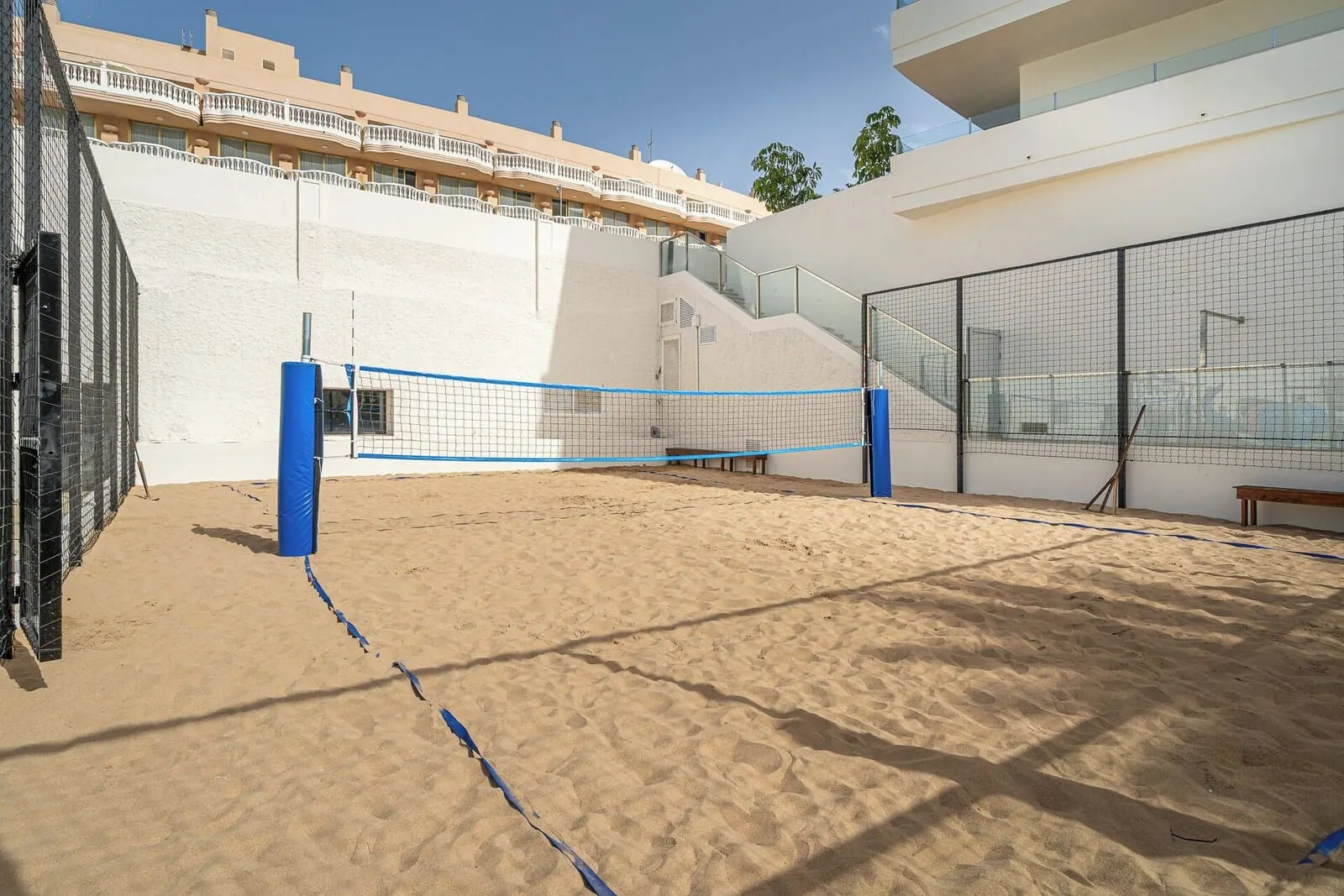 Mediterranean Palace: A beach volleyball court with a net, benches