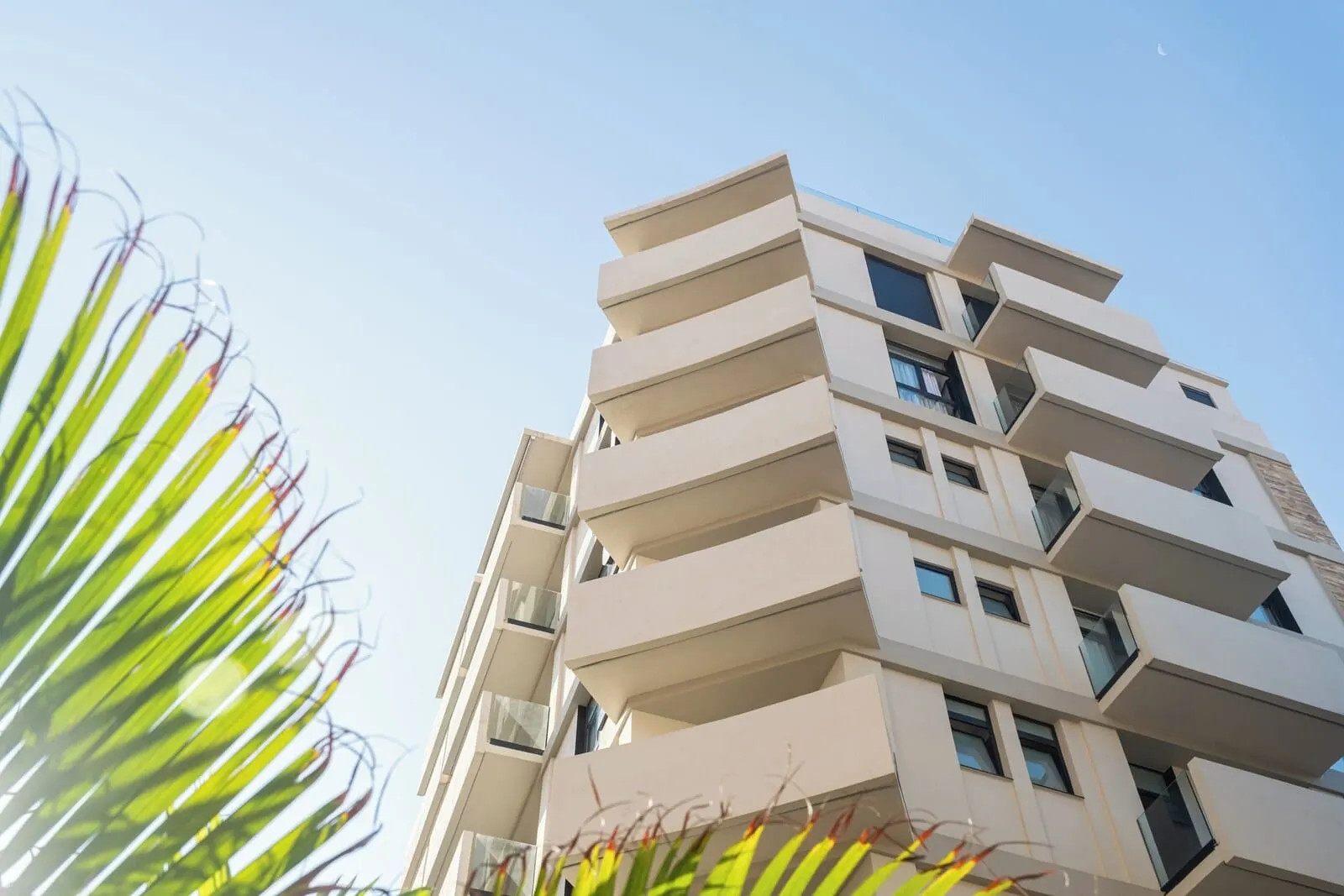 Hotel Adonis Capital: A multi-story building with balconies and large windows