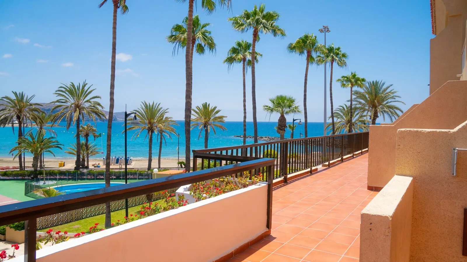 Coral Compostela Beach: A balcony with a view of the sea, palm trees, and a pool