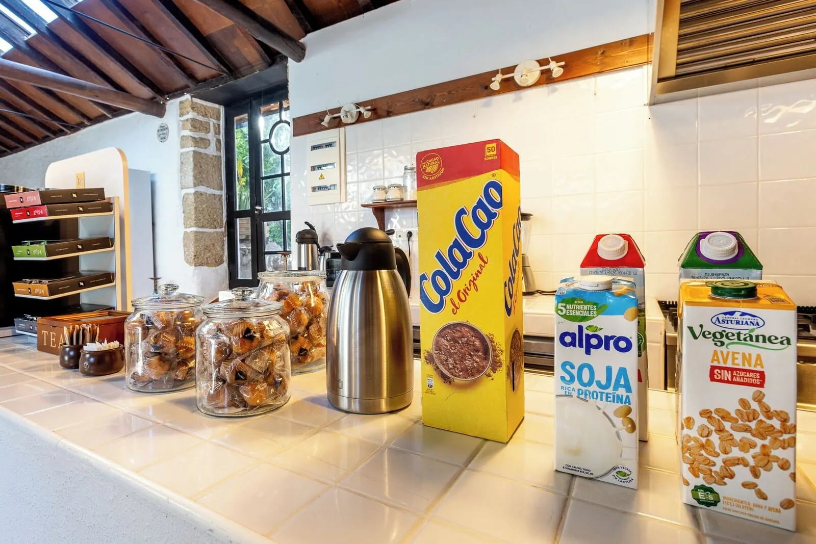Hotel Duque de la Torre: A kitchen counter with various food items and cartons of milk