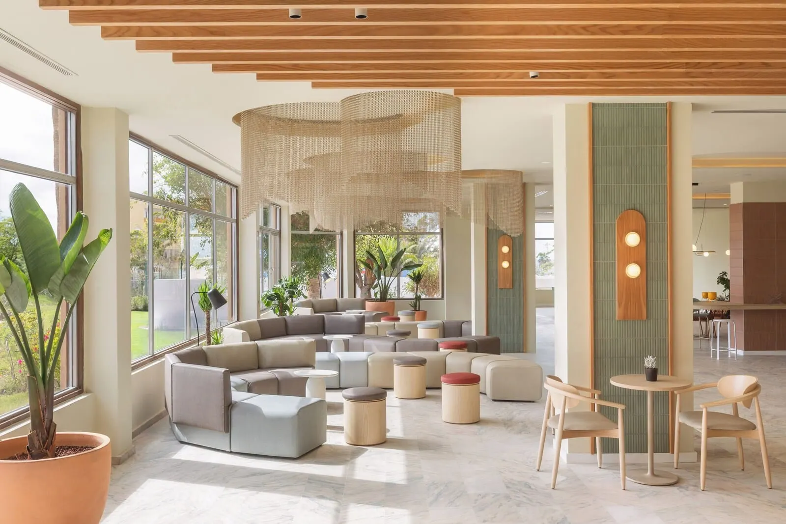 Sol Arona Tenerife: A modern lounge area with a sectional sofa, round ottomans