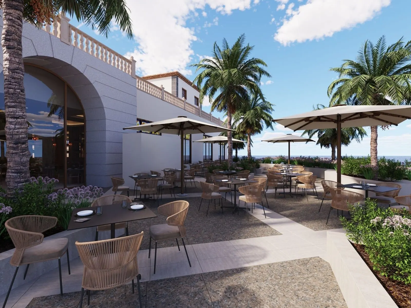 Bahia Principe Explore Costa Adeje: An outdoor patio with tables and chairs, palm trees, and a view of the ocean