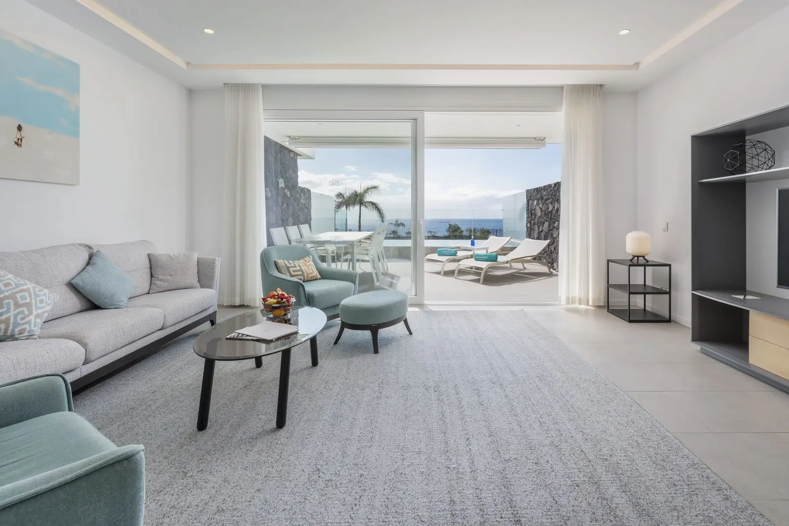 Royal Hideaway Corales Suites: A modern living room with a sofa, armchairs, a coffee table