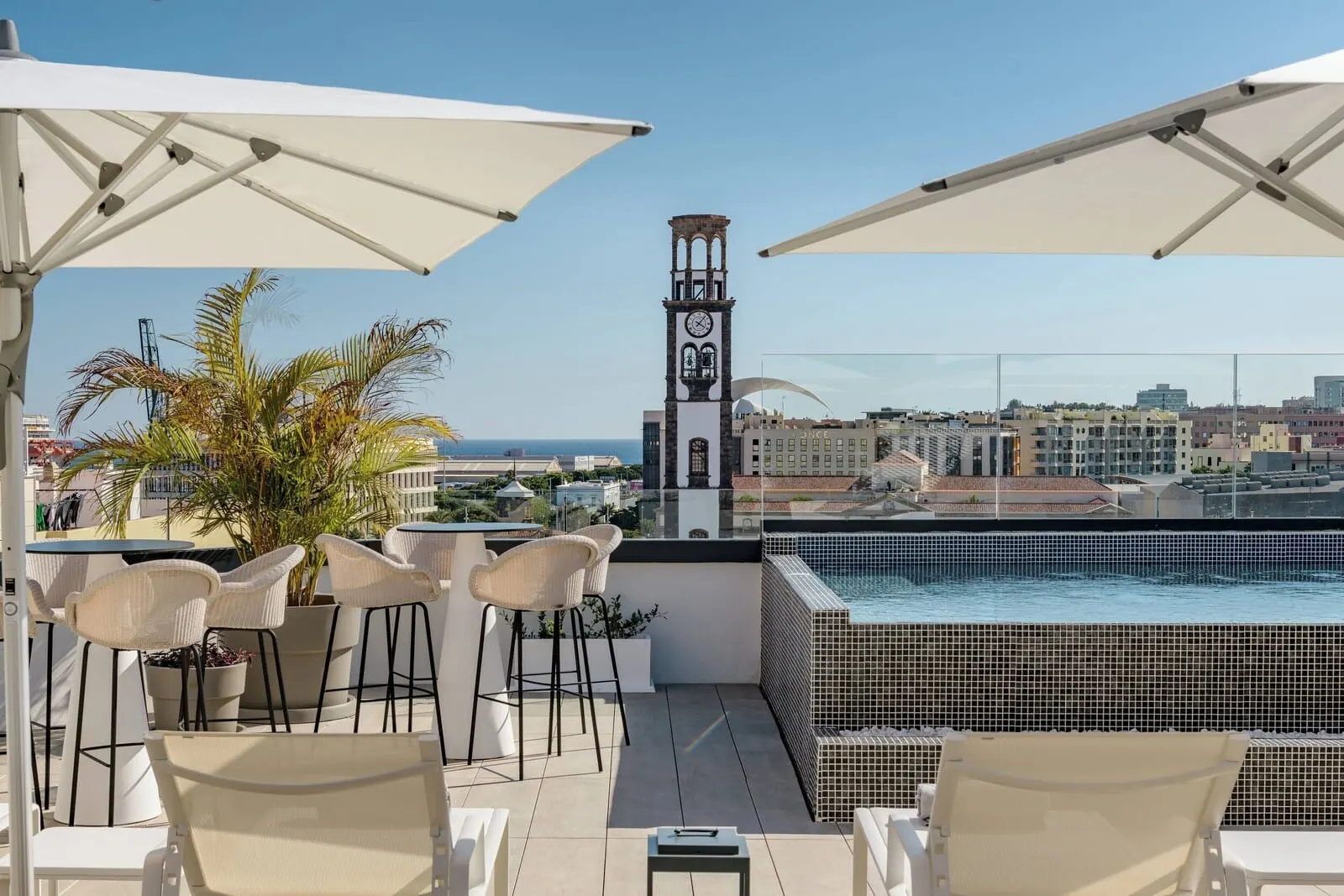 AC Hotel Tenerife: A rooftop terrace with a pool, white chairs