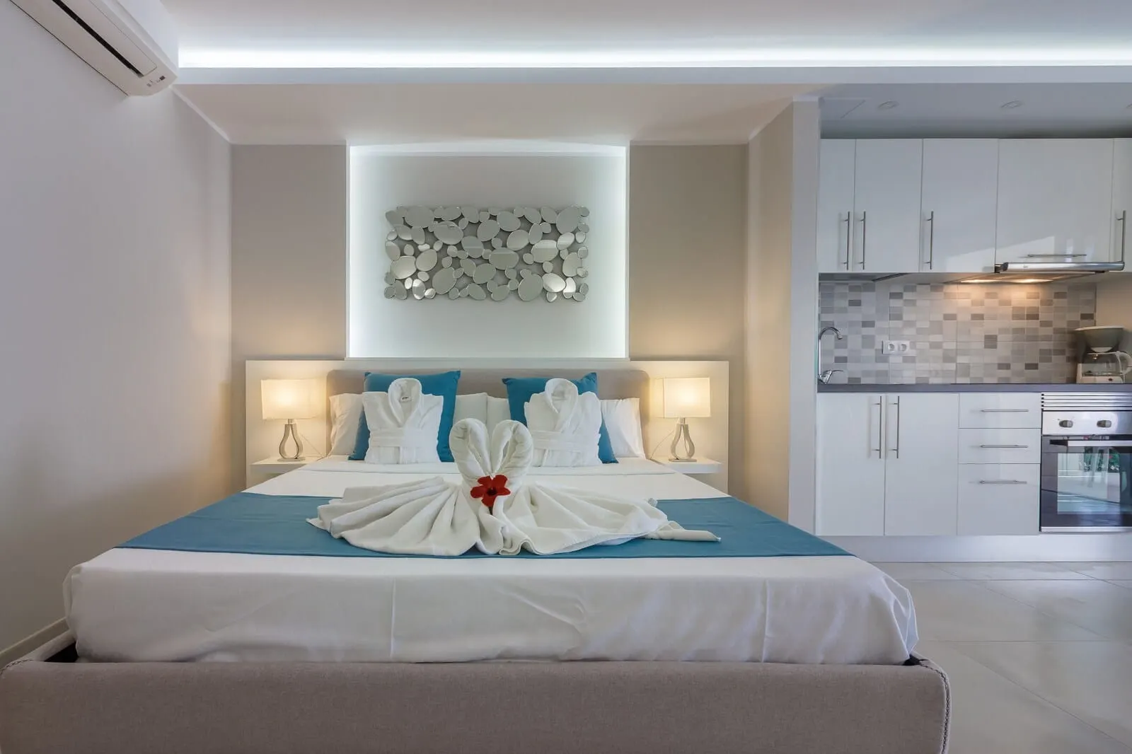 Klayman Diamond Aparthotel: A hotel room with a neatly made bed, a modern kitchen in the background