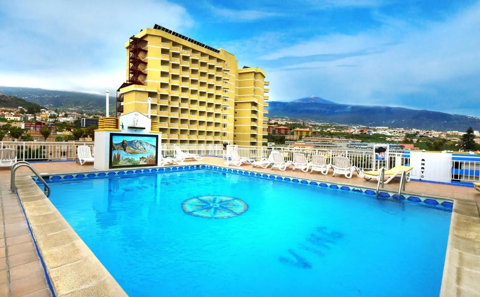 Skyview Hotel by LIVVO: A swimming pool with lounge chairs and a mural