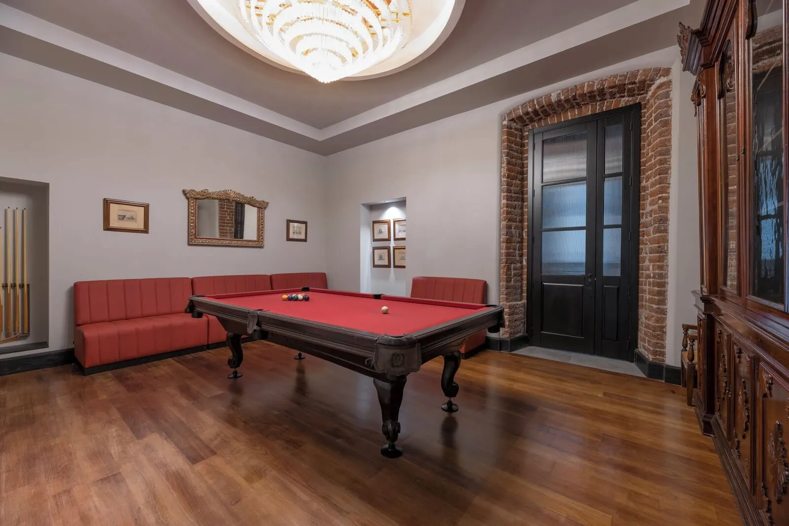 TUI BLUE Atlantic Hills: A billiards room with a pool table, red seating, framed pictures, and a brick wall