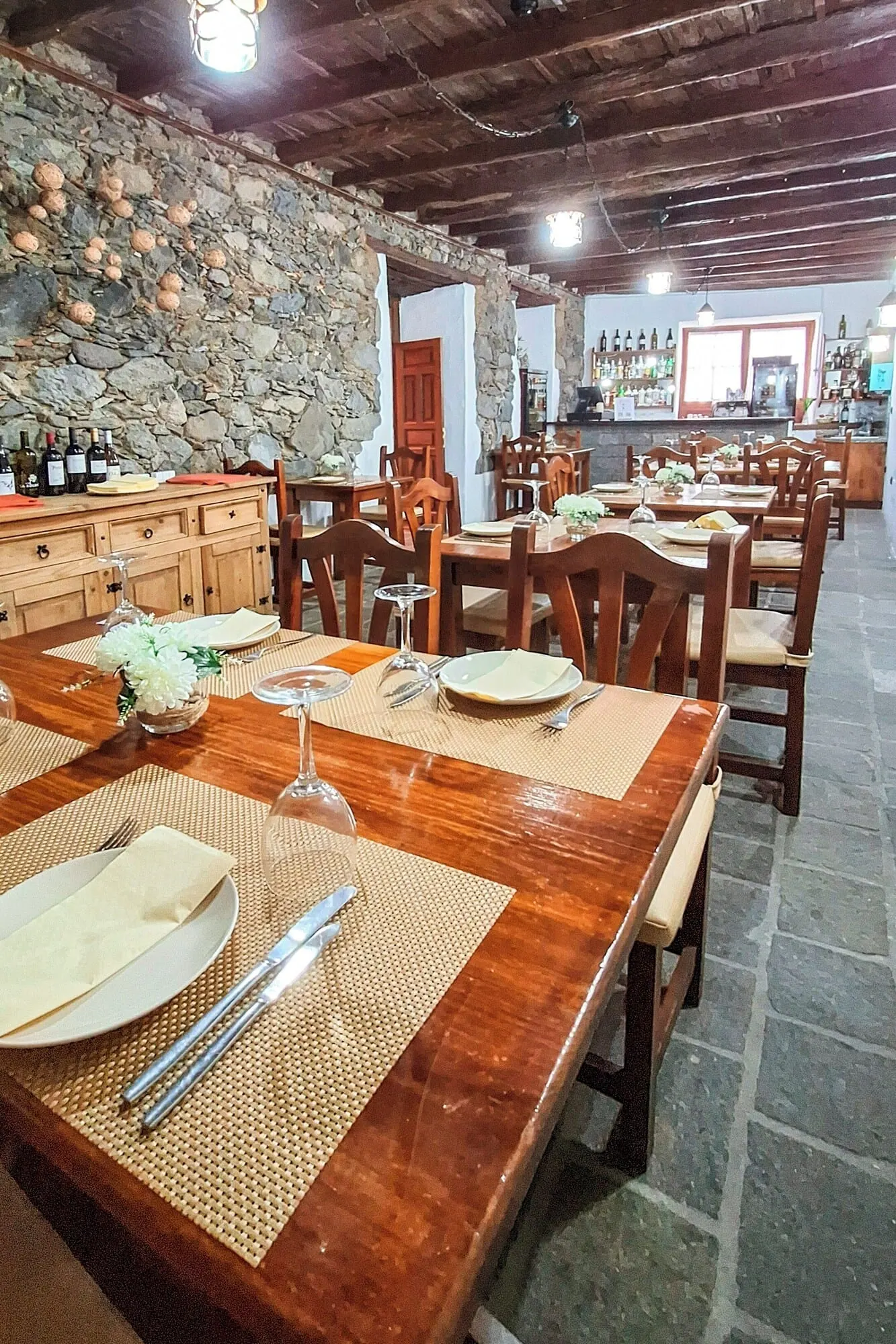 Hotel Rural Bentor: A restaurant with wooden tables and chairs, stone walls