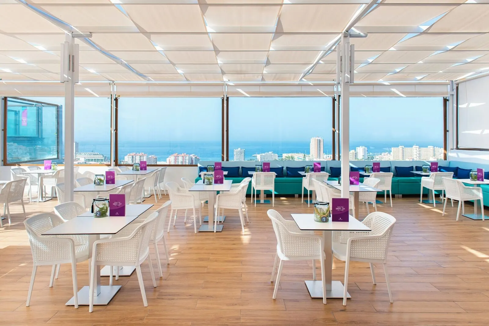 Paradise Park Fun Lifestyle Hotel: A spacious indoor area with tables and chairs, large windows offering a city view