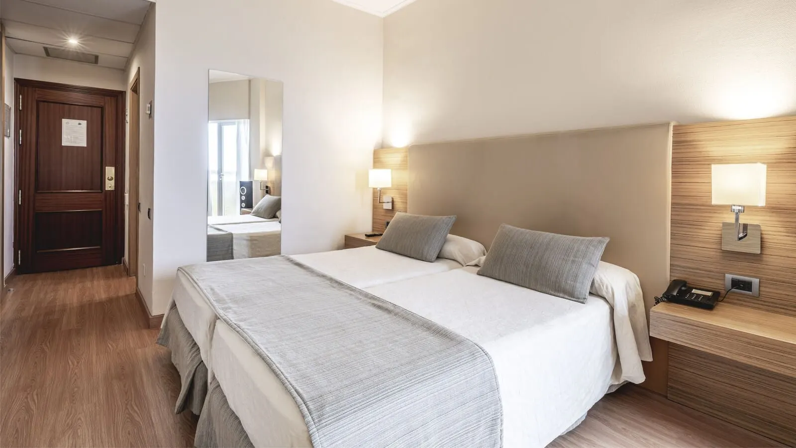 Be Live Adults Only Tenerife: A hotel room with a large bed, bedside lamps, a nightstand with a phone