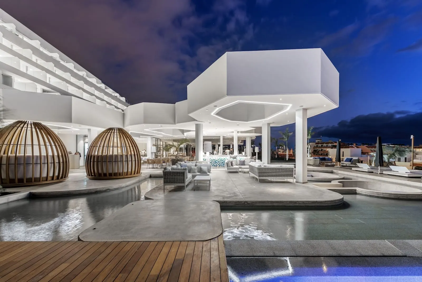 Royal Hideaway Corales Beach: A modern hotel with a spacious outdoor area featuring a pool, seating areas