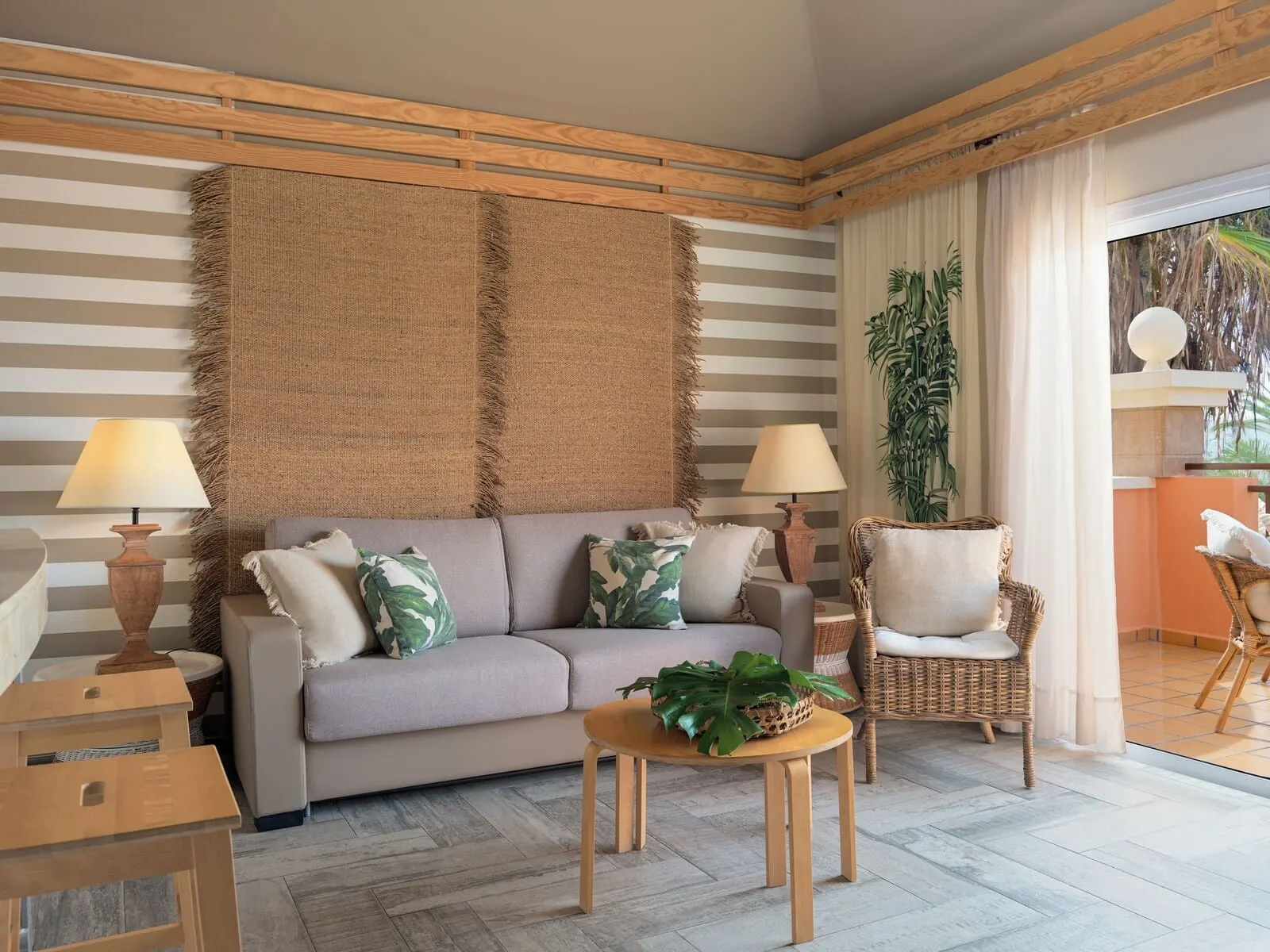 Green Garden Eco Resort & Villas: A living room with a sofa, two side tables, a coffee table, and a large woven rug