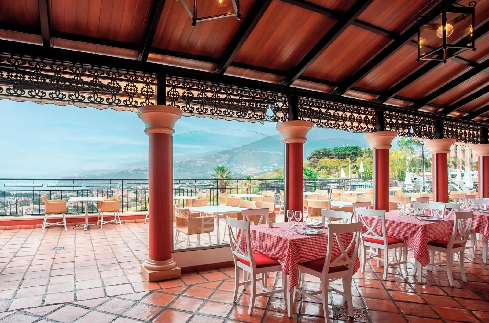 Hotel Las Águilas Tenerife, Affiliated by Meliá: A terrace with tables and chairs, a view of the sea, and a mountainous landscape