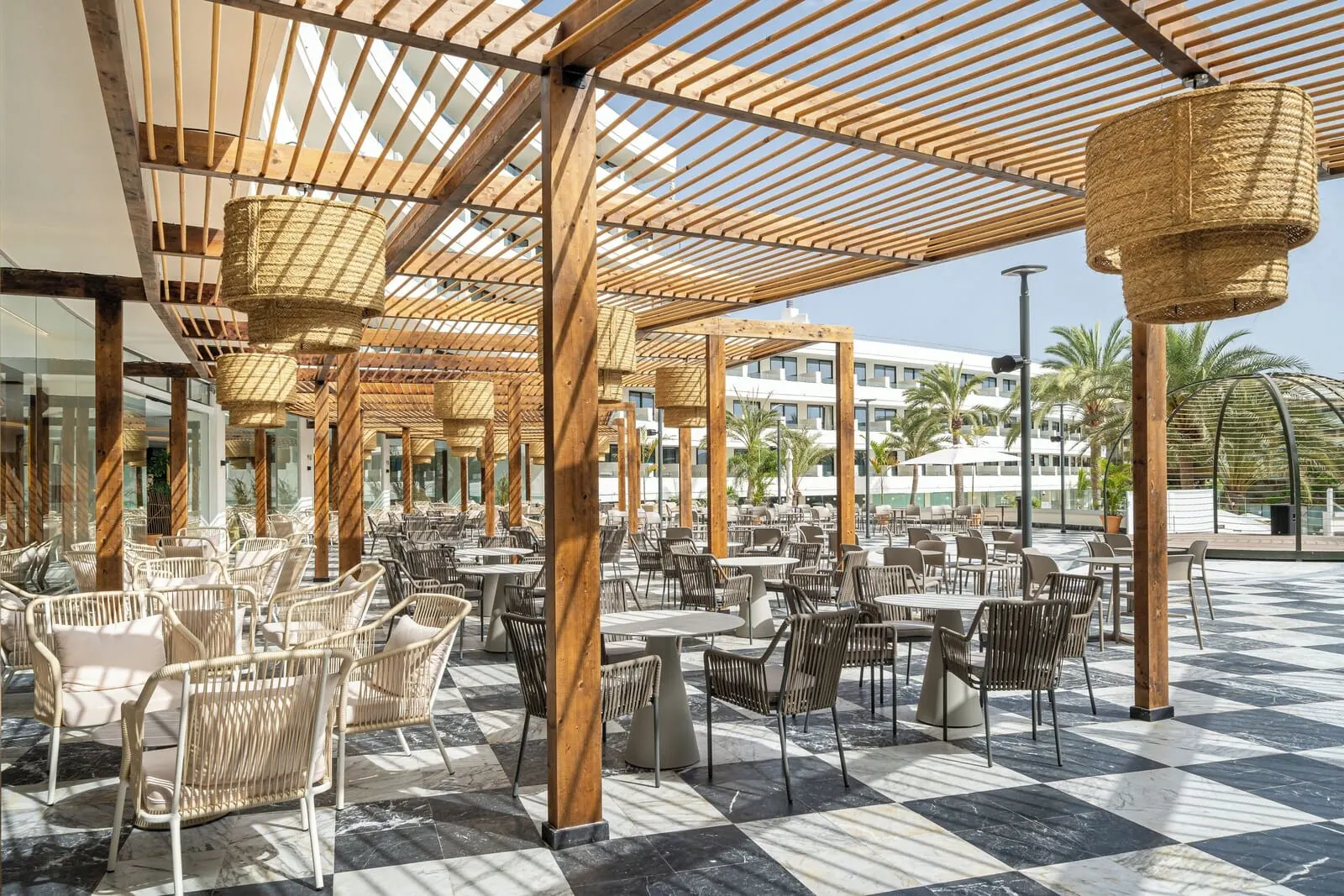 Mediterranean Palace: An outdoor cafe area with wicker furniture, a checkered floor