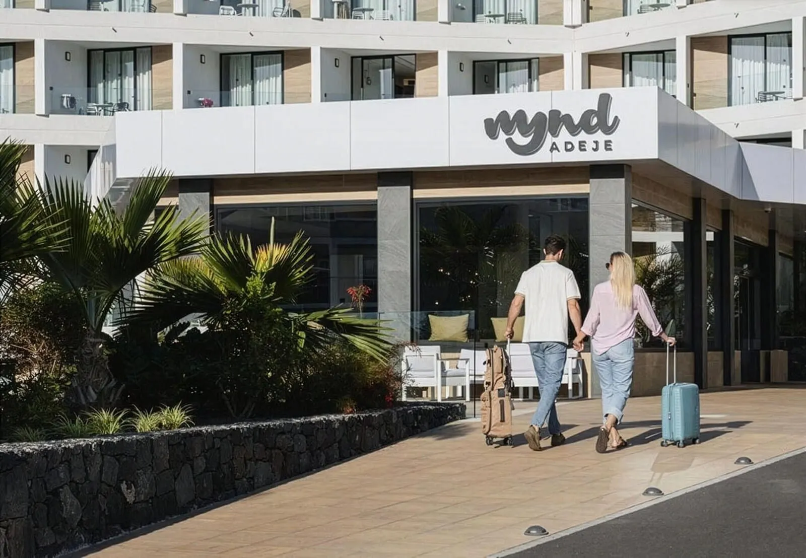 MYND Adeje: A hotel entrance with a modern design, a signboard