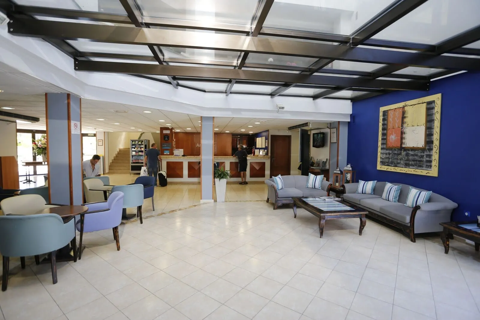 Hotel Andorra: A spacious lobby with a modern design, featuring a blue accent wall, a large sofa