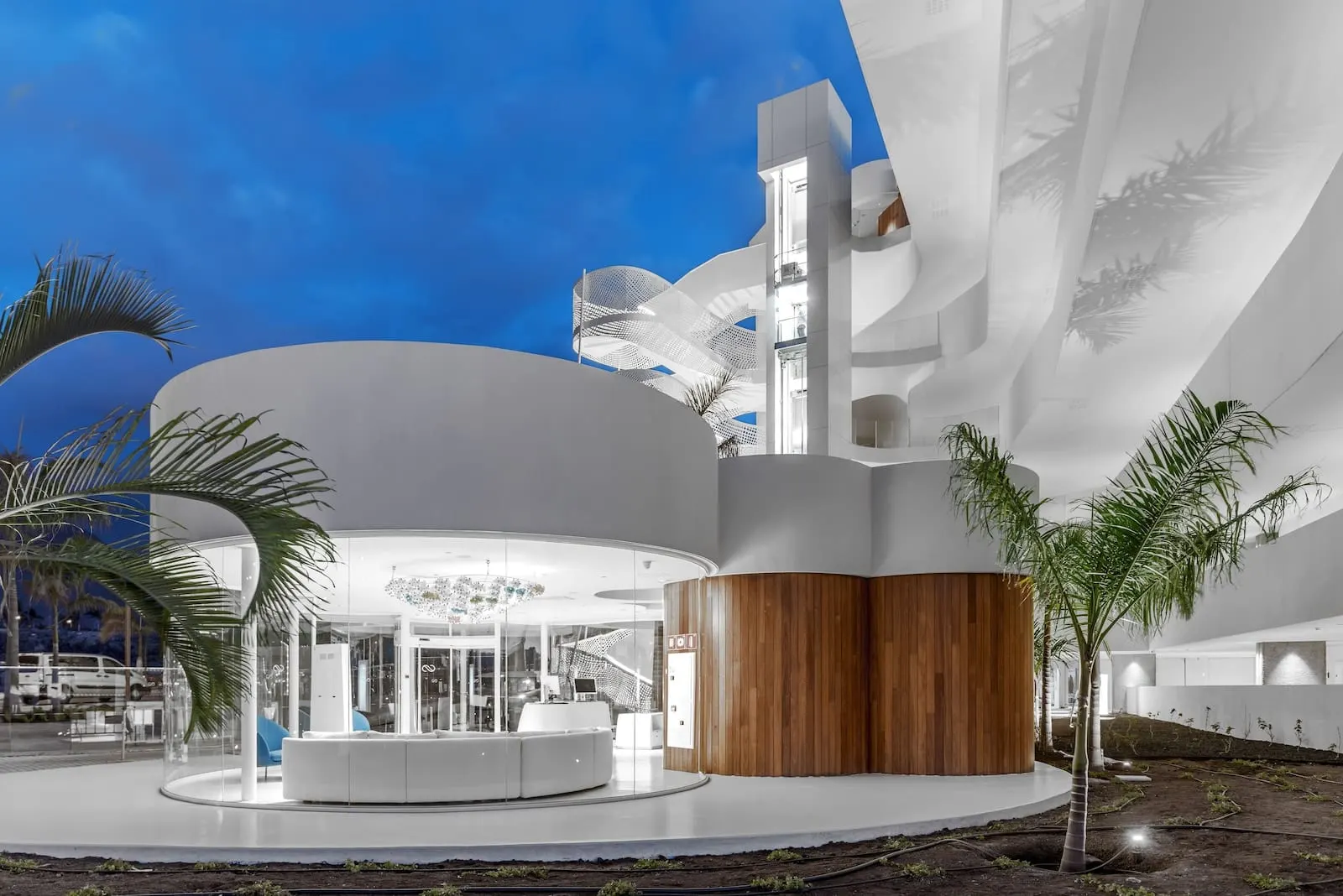 Royal Hideaway Corales Beach: A modern building with a curved facade, a central seating area