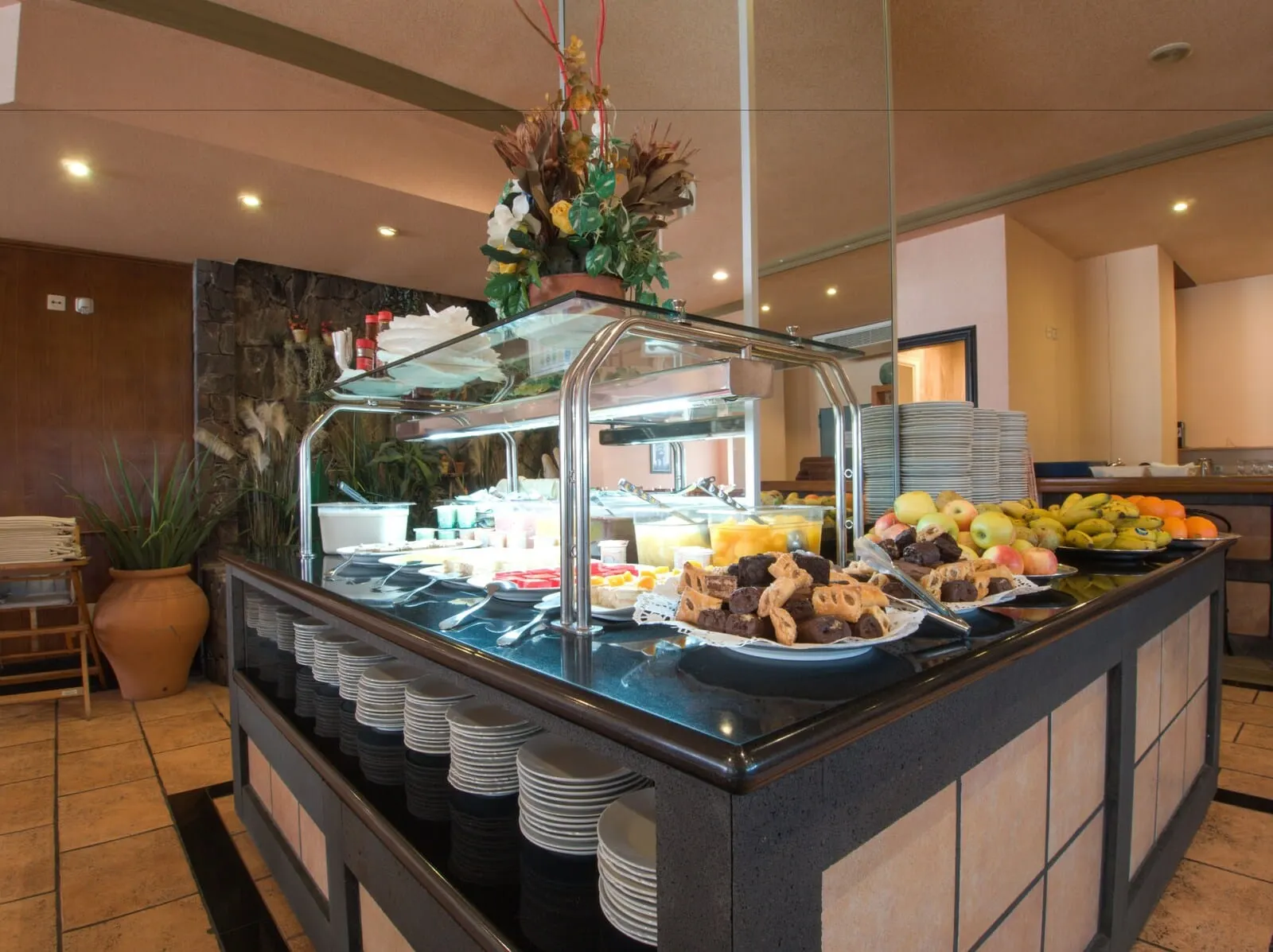 Hotel Zentral Center: A buffet area with a variety of food items, including fruits, pastries, and beverages